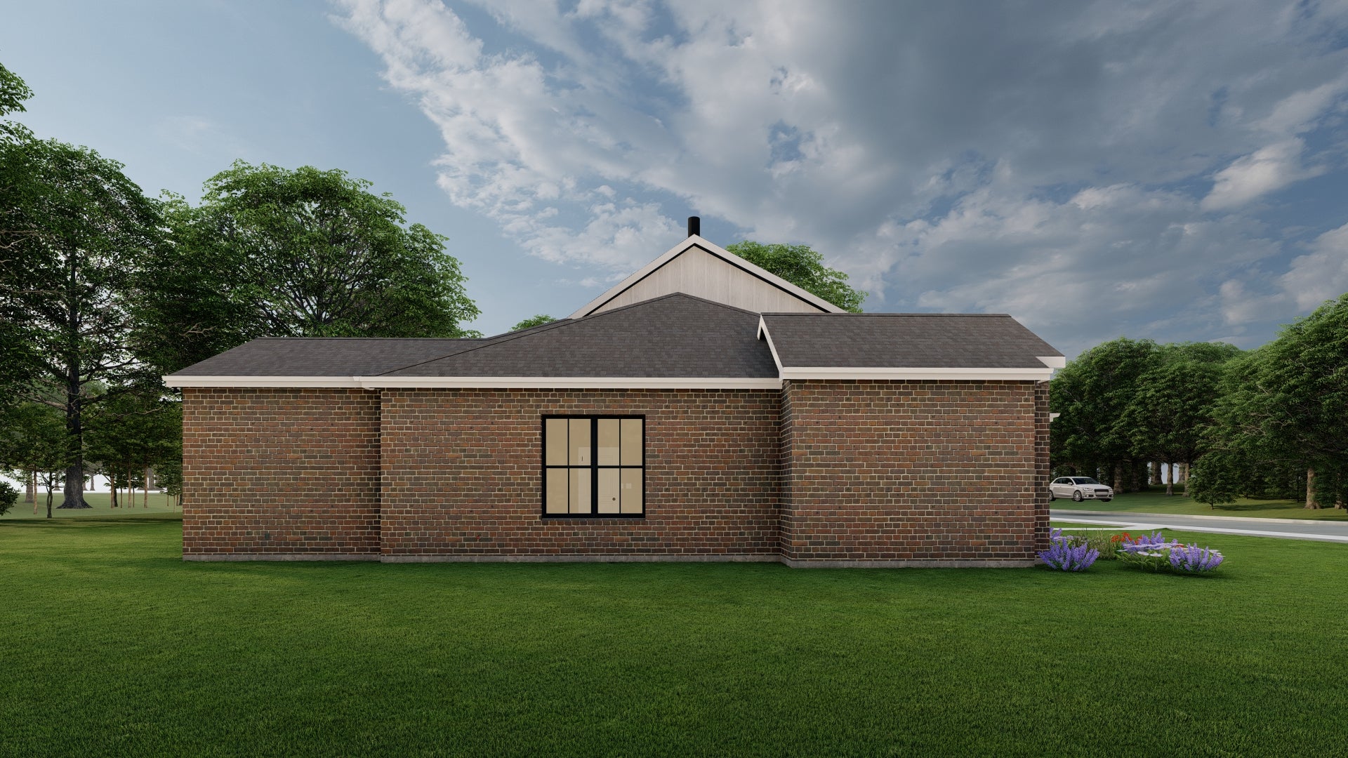 Brick house with a gray roof in a green landscape with trees and a blue sky.